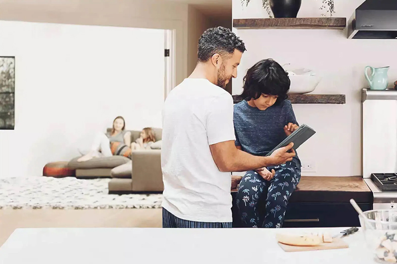 Father and son using a table on Wi-Fi. Learn more about AccessSmart Wi-Fi+ 